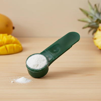 Digest-All Plus digestive enzyme powder in scoop on natural surface showing clean, concentrated formula
