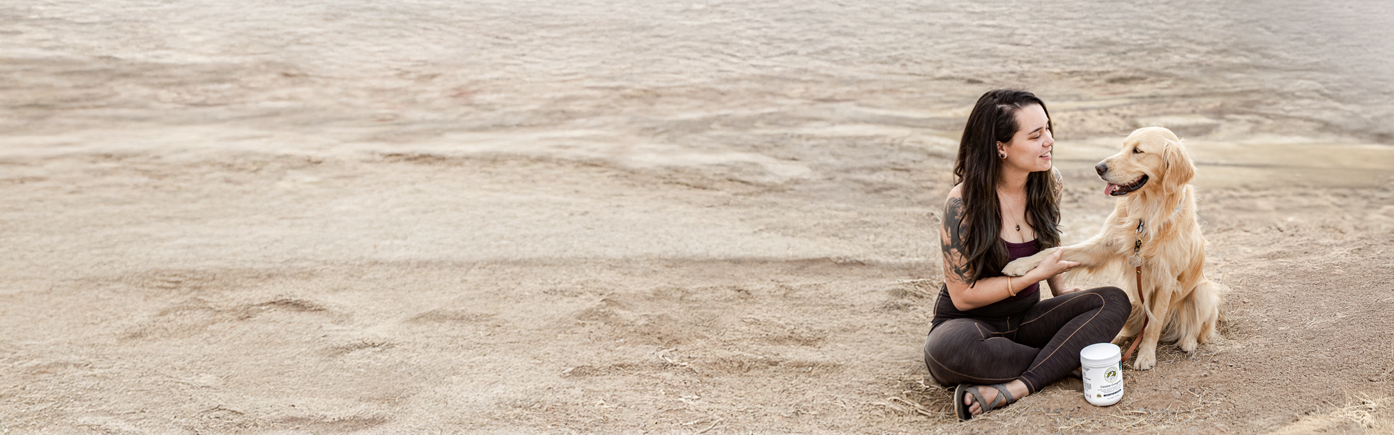 Healthy dog and owner outdoors representing Wholistic Pet Organics best selling natural pet supplements made from whole-food ingredients.